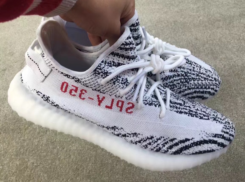 white yeezys with red writing off 60 