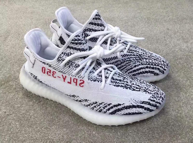 white yeezys with red writing