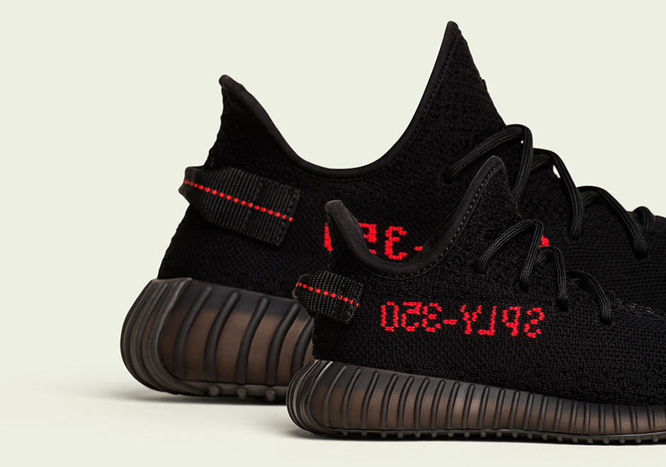 black yeezys with red writing