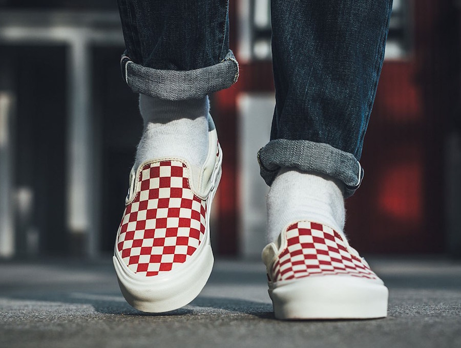 checkerboard slip on vans on feet