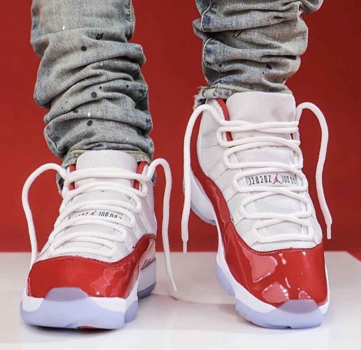 https://sneakerbardetroit.com/wp-content/uploads/2022/08/Air-Jordan-11-Cherry-On-Feet-1.jpg