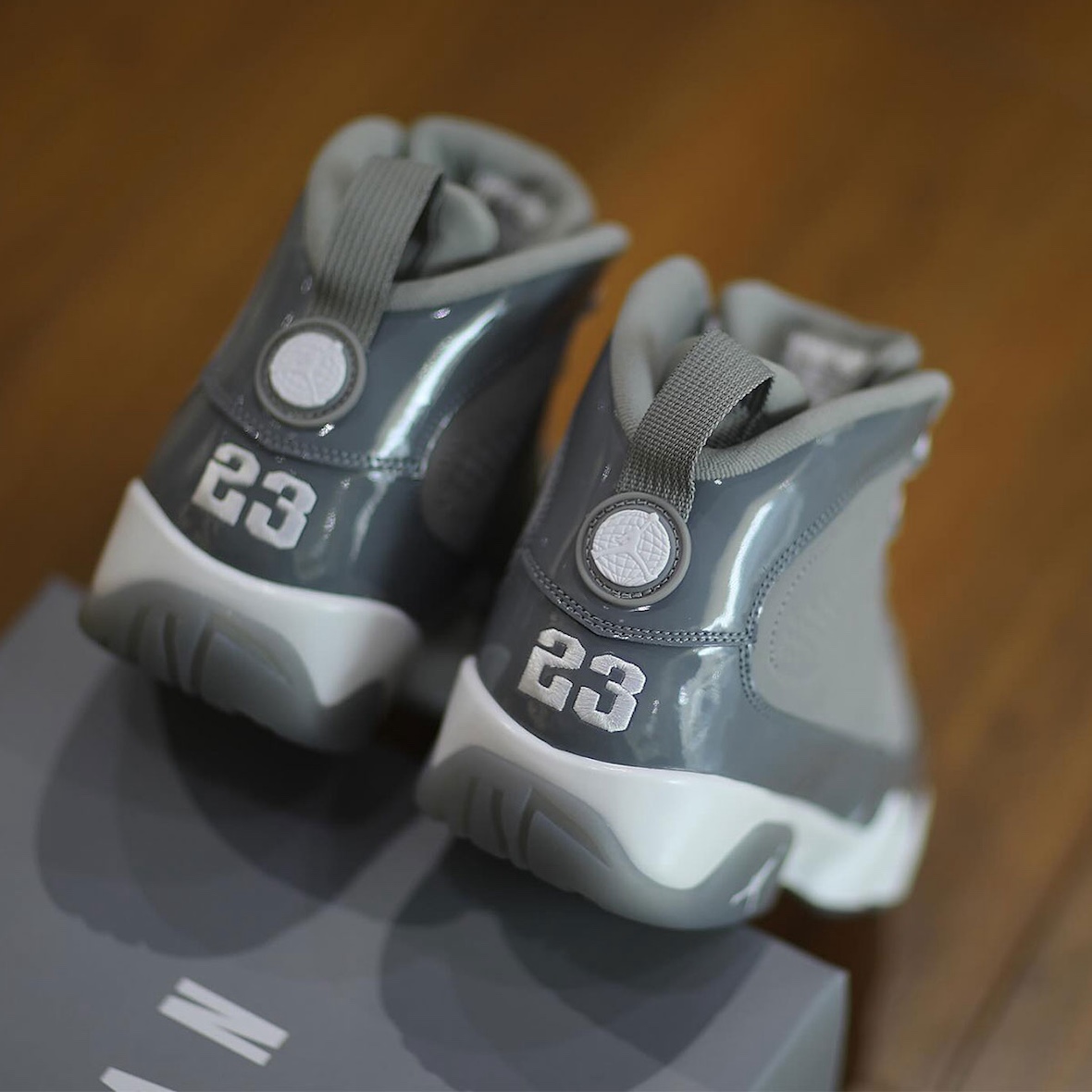 Rear view of Air Jordan 9 "Cool Grey" 2025 highlighting the embroidered "23" heel detail, glossy patent leather accents, and signature pull tab.