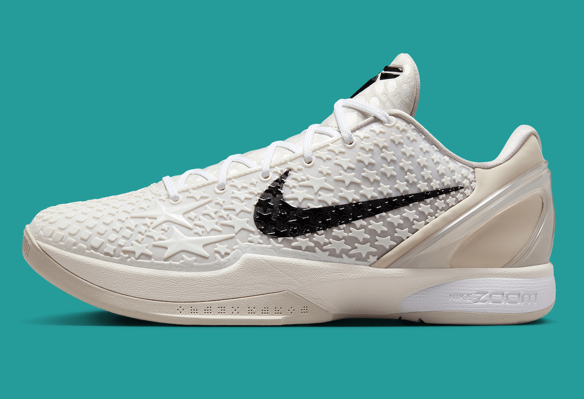 Side view of the Nike Kobe 6 Protro All-Star 2.0, showcasing the star-embossed white upper, black Swoosh, and cream midsole with Zoom Air cushioning.