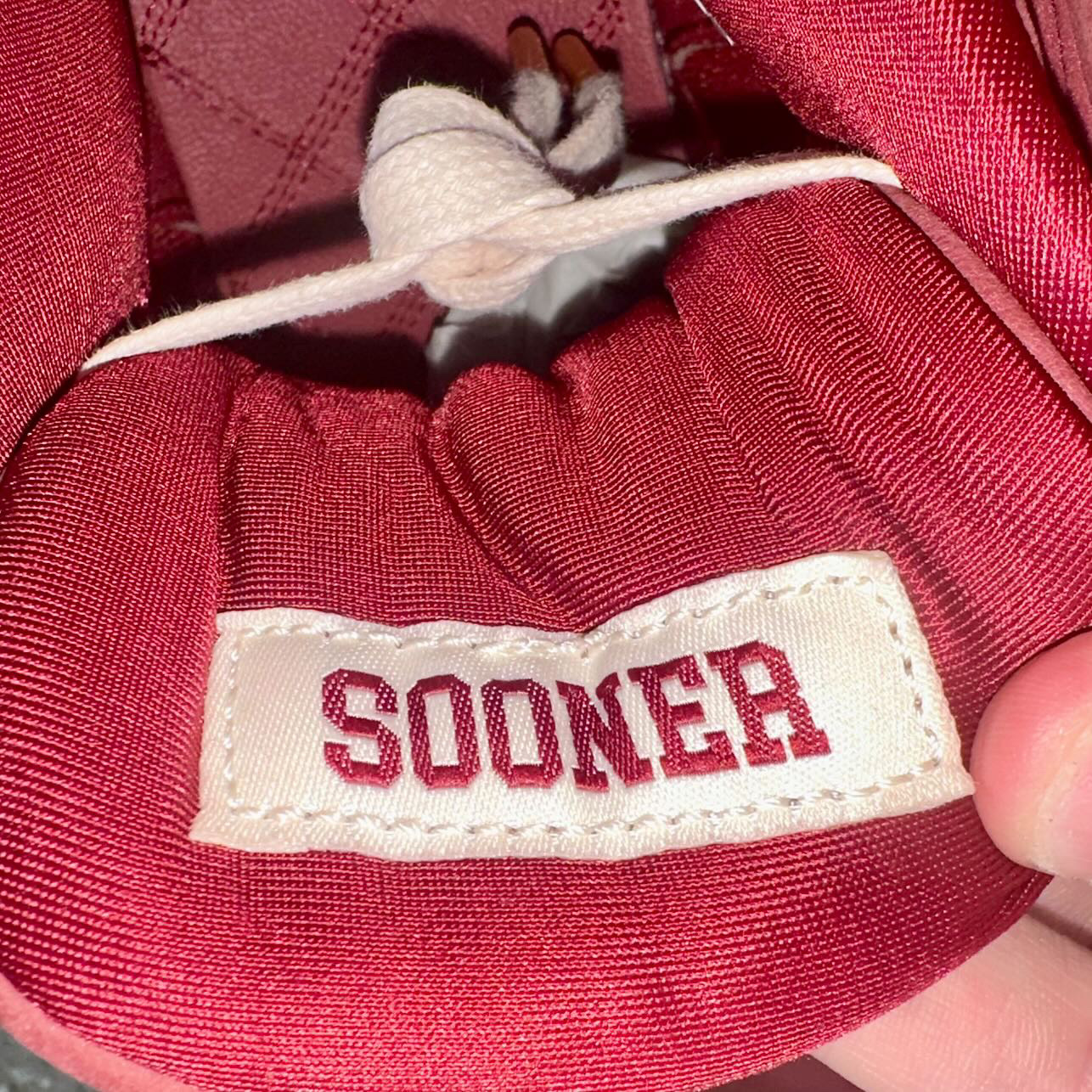 Inner tongue details of the Air Jordan 4 Oklahoma Sooners PE displaying Sooner embroidery
