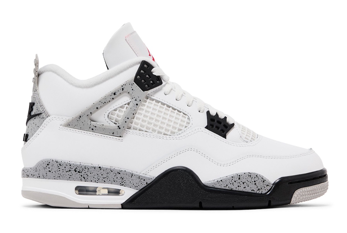 A side profile shot of the Air Jordan 4 "White Cement" 2025, showcasing its white leather upper, grey-speckled midsole, and black detailing.