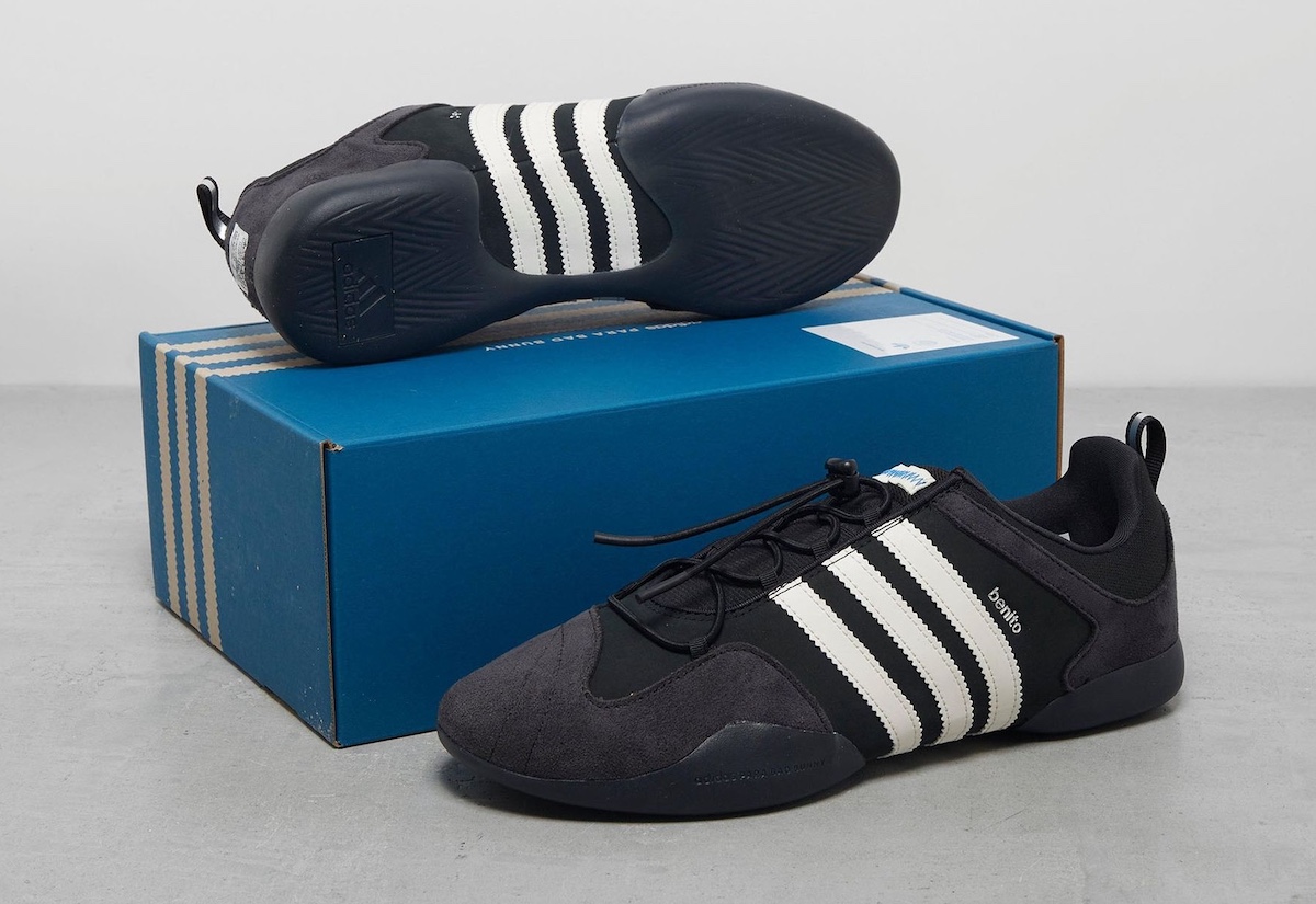 The sneaker displayed with its original blue adidas packaging.