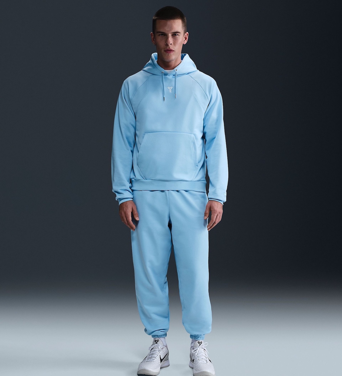 A model wearing the Nike Kobe Psychic Blue hoodie and sweatpants.