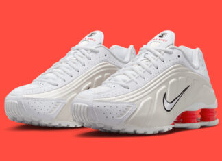 Side view of the Nike Shox R4 White/Phantom showcasing its perforated leather upper and red Shox columns.