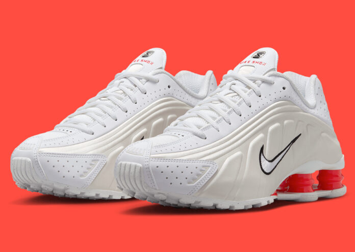 Side view of the Nike Shox R4 White/Phantom showcasing its perforated leather upper and red Shox columns.
