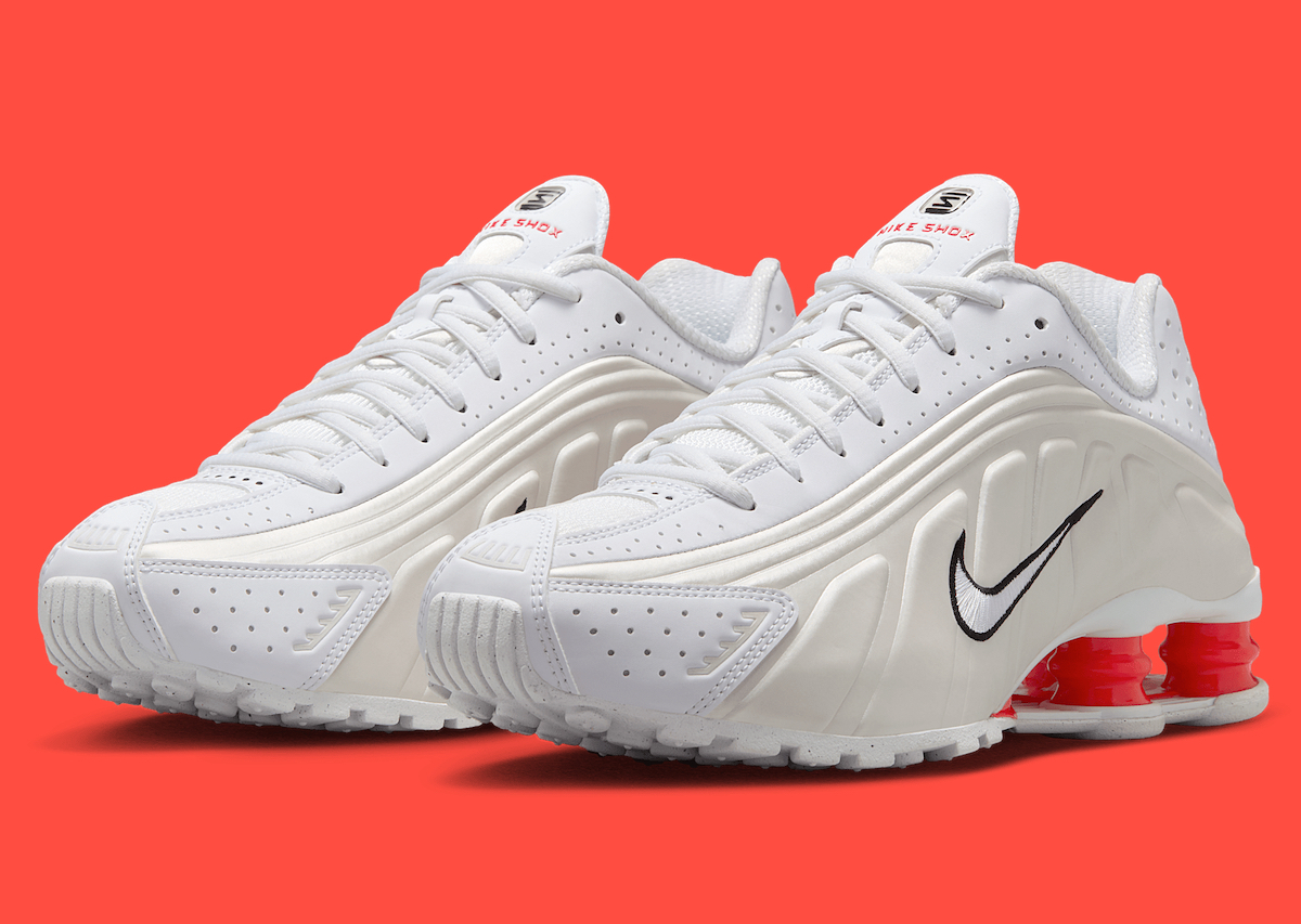 Side view of the Nike Shox R4 White/Phantom showcasing its perforated leather upper and red Shox columns.