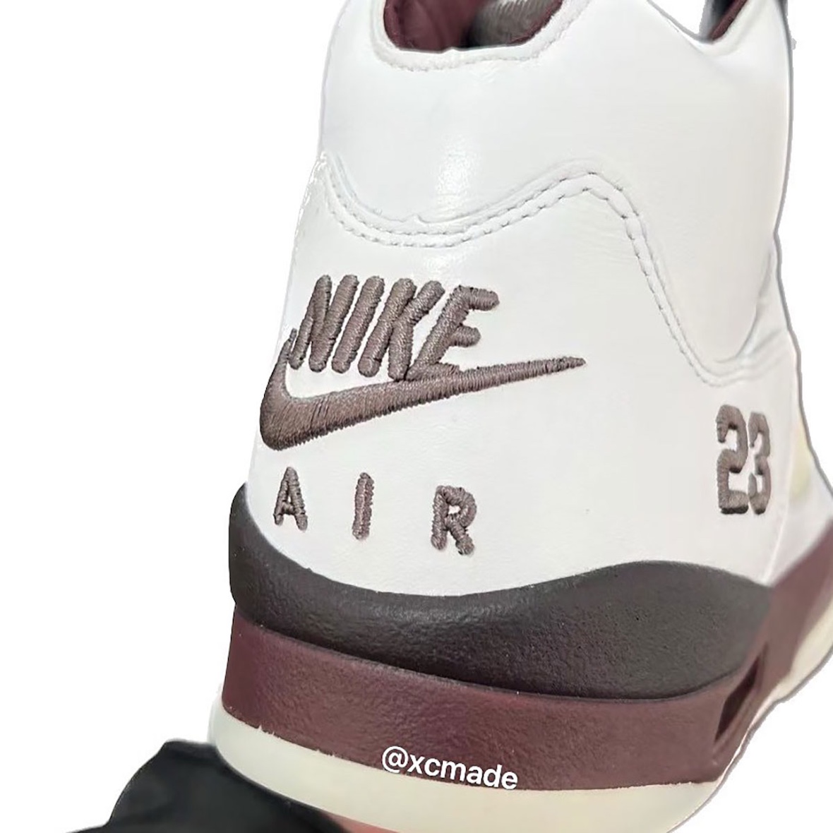 The back heel of the A Ma Maniere x Air Jordan 5 Violet Ore Burgundy Crush featuring embroidered Nike Air branding and a stitched '23' detail in burgundy, emphasizing the sneaker's retro-inspired aesthetics.