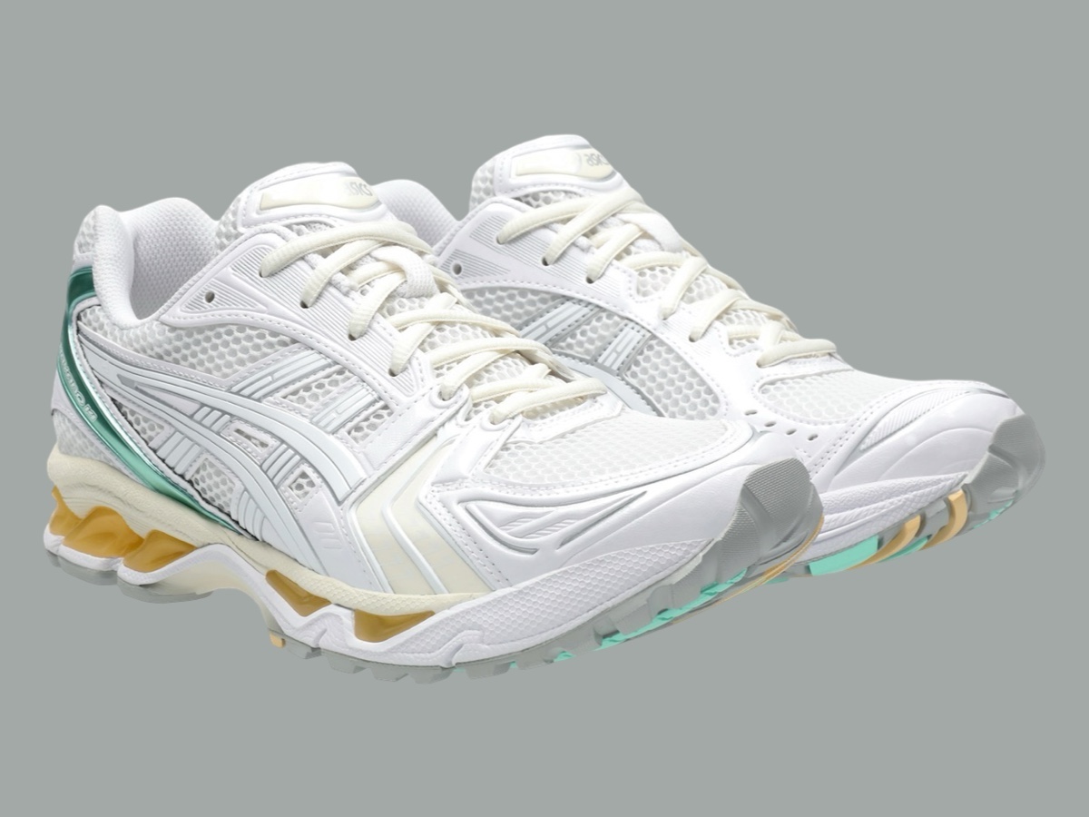 Angled view of the sneaker, highlighting the white mesh upper and glossy green heel details.