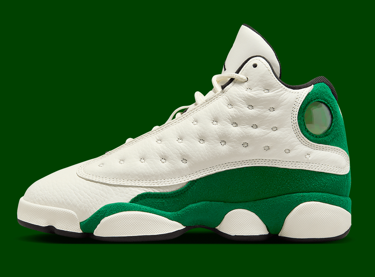 Side profile of the Air Jordan 13 GS Pine Green showcasing premium white leather and vibrant green suede panels.