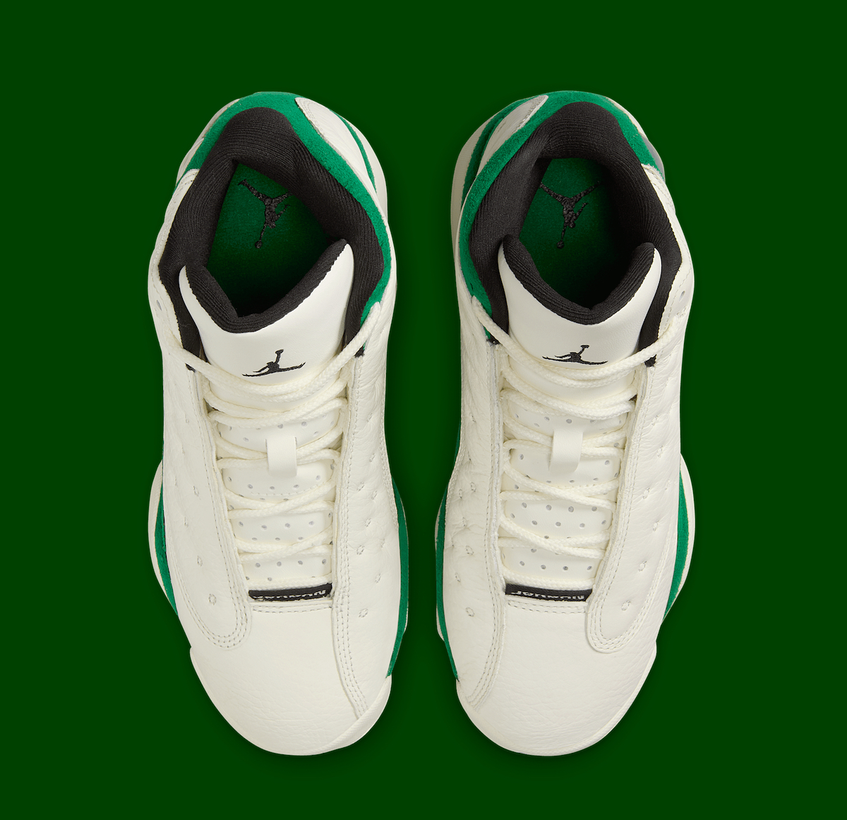 Top view of the Air Jordan 13 GS Pine Green highlighting the perforated leather design and black Jumpman logo on the tongue.