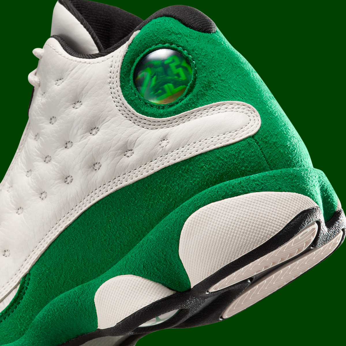 Close-up of the Air Jordan 13 GS Pine Green hologram detail, emphasizing the tumbled leather and textured suede materials.