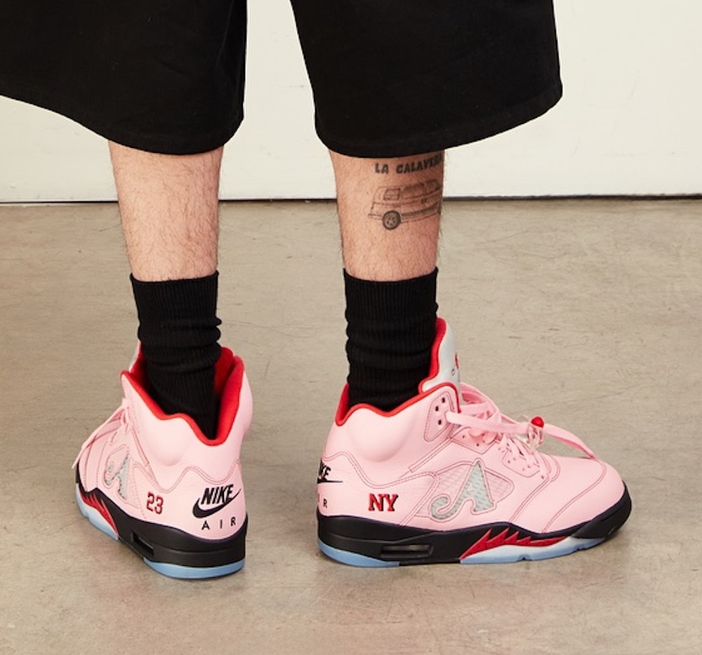 Awake NY x Air Jordan 5 Arctic Pink 2025 – Rear view highlighting embroidered "23", Nike Air branding, and "NY" text on the pink upper with icy blue outsole and black midsole.
