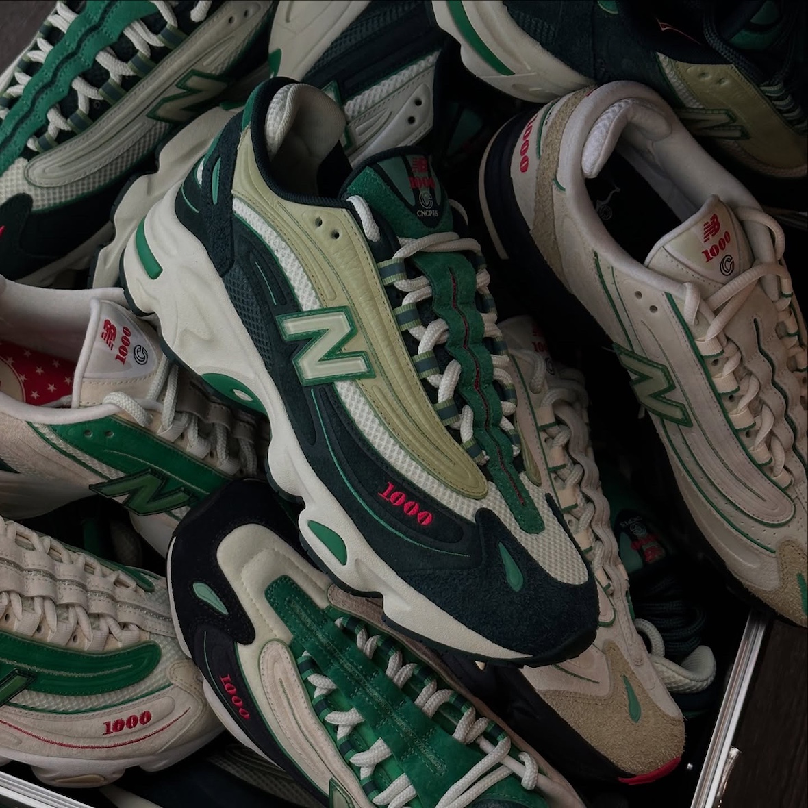Concepts x New Balance 1000 - multiple colorways displayed, featuring mesh, leather, and suede materials in green tones.