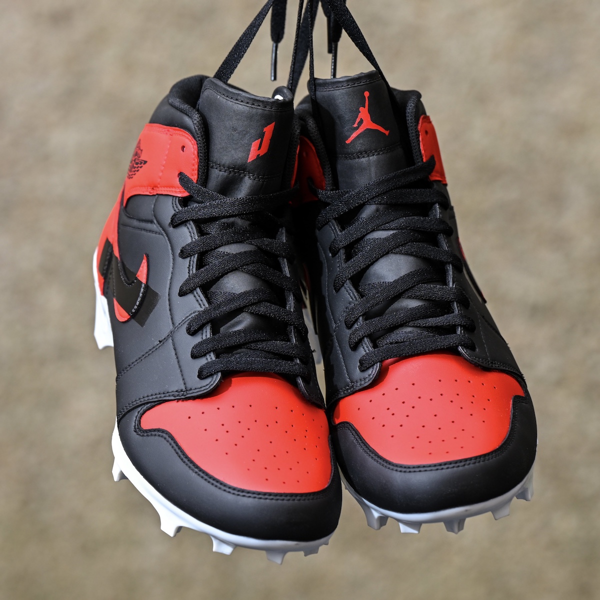 Top view of the cleats showcasing Hurts' custom PE logo on the right tongue