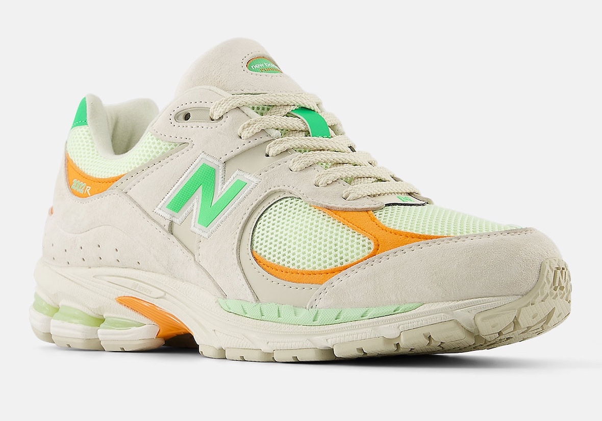 Side view of the New Balance 2002R "Green Apple" showcasing green and orange suede overlays.