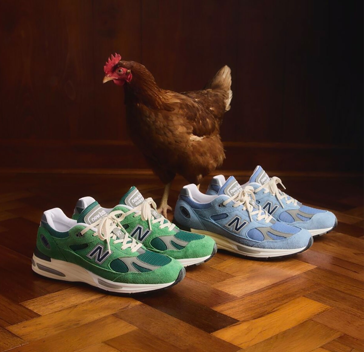 New Balance 991v2 Lucky Green and Light Blue colorways with a chicken in the background