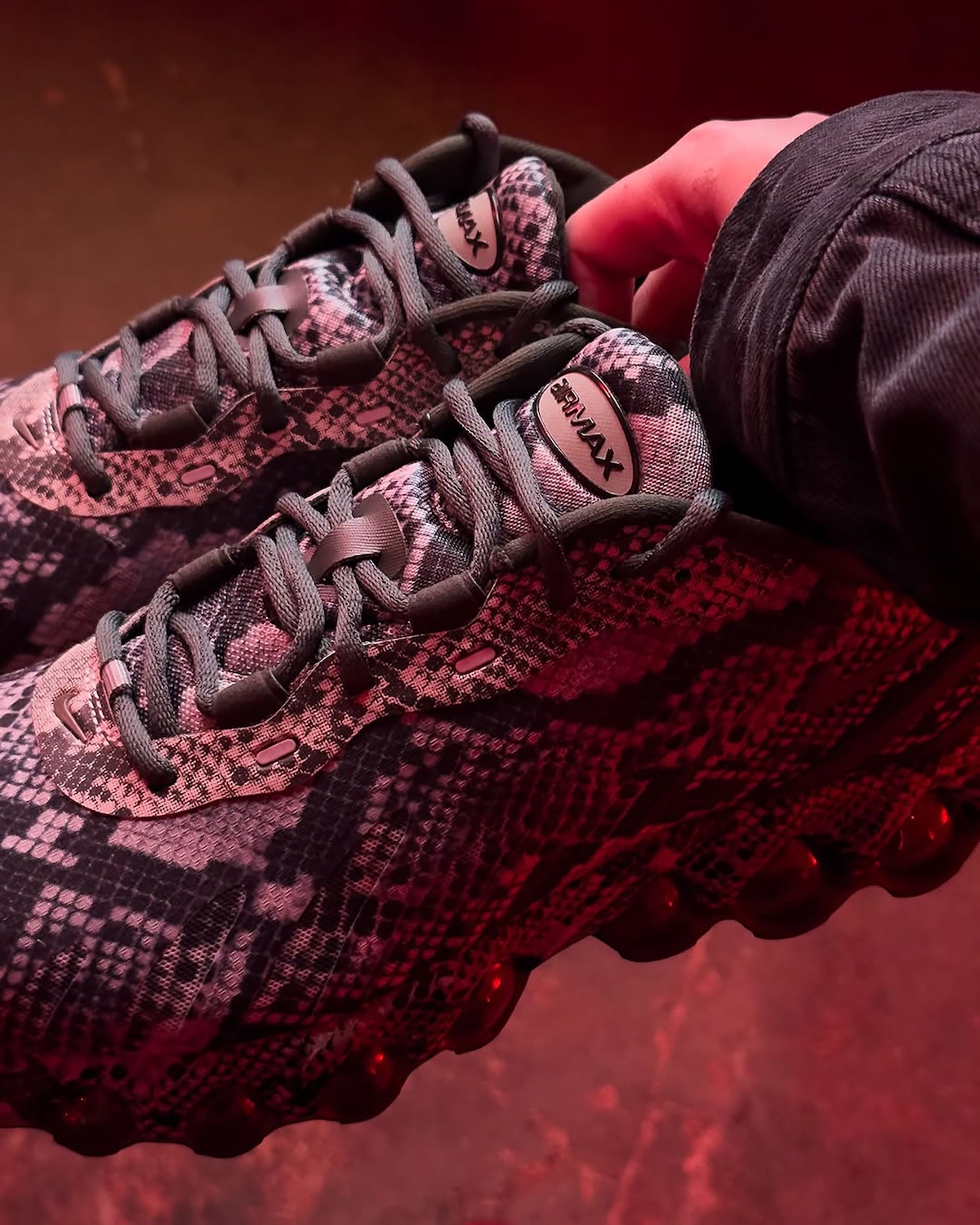 Close-up of the Nike Air Max Dn8 Snakeskin highlighting the tongue branding and textured laces.