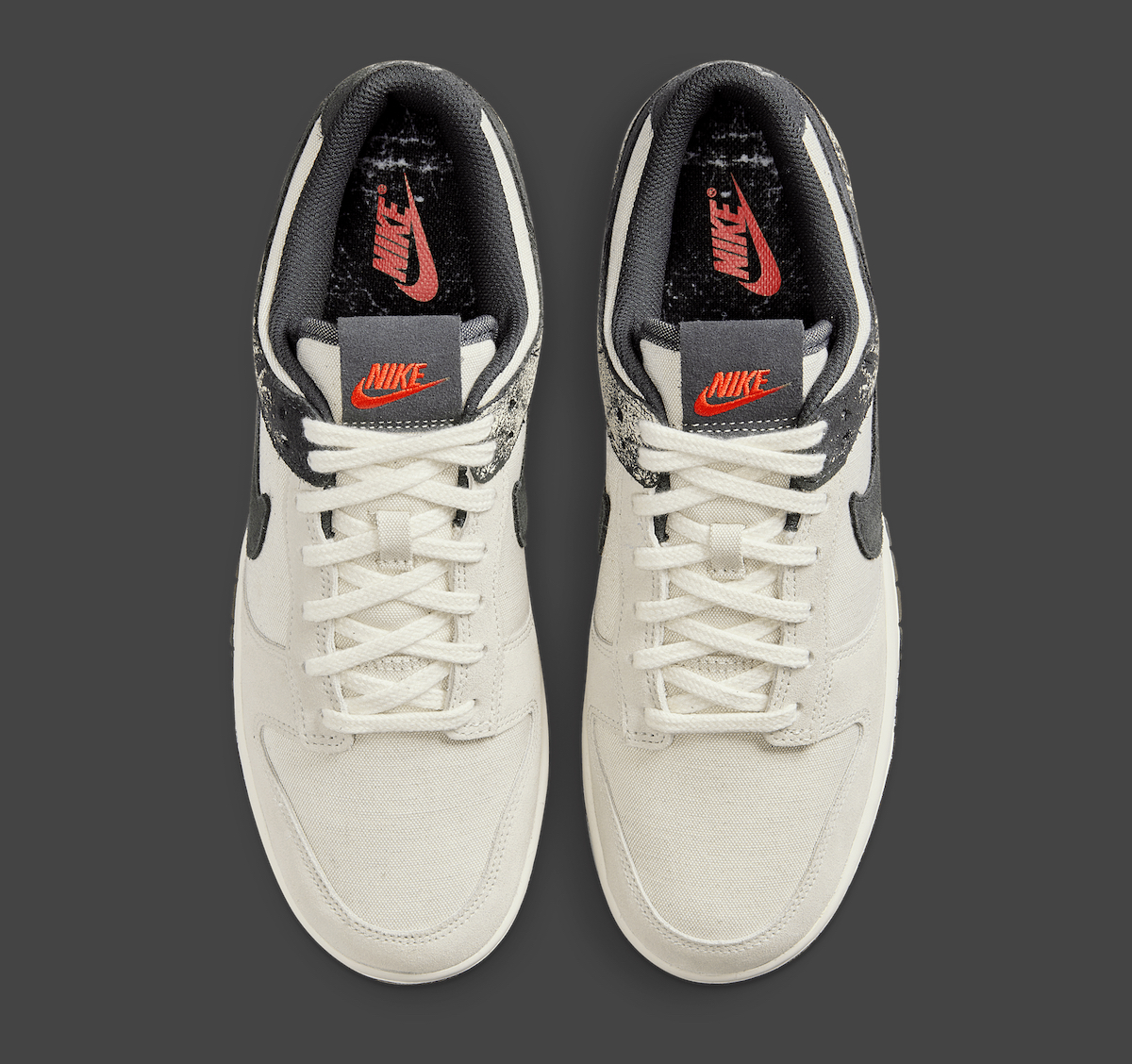Top view of Nike Dunk Low Pale Ivory Off Noir highlighting red Nike tongue branding.