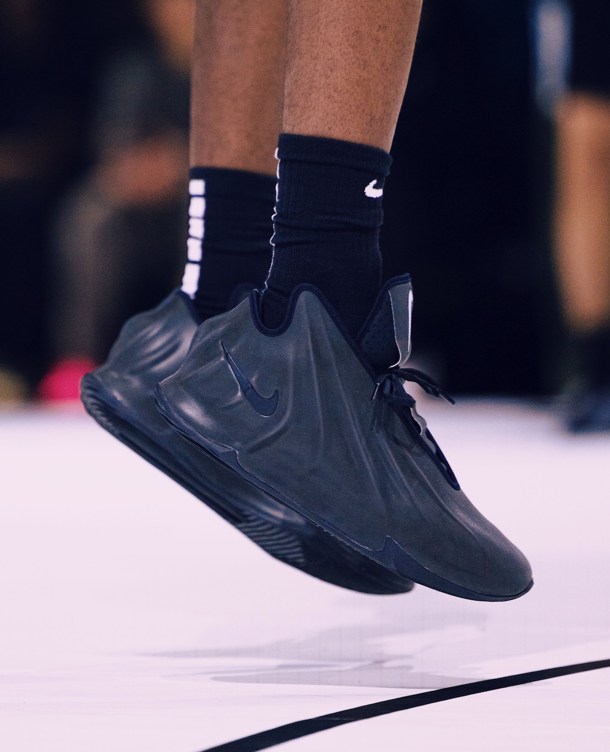 A close-up of AJ Dybantsa in mid-air wearing the Nike GT Future Black, highlighting the shoe’s futuristic Foamposite-inspired design and lightweight build for high-performance basketball play.
