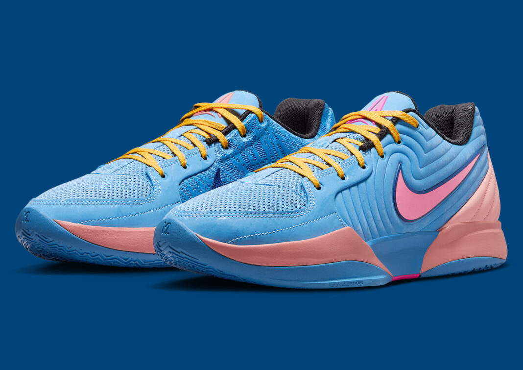 A pair of Nike Ja 2 Blue Beyond sneakers displayed against a blue background, featuring a bright blue upper, pink and apricot accents, and yellow laces.