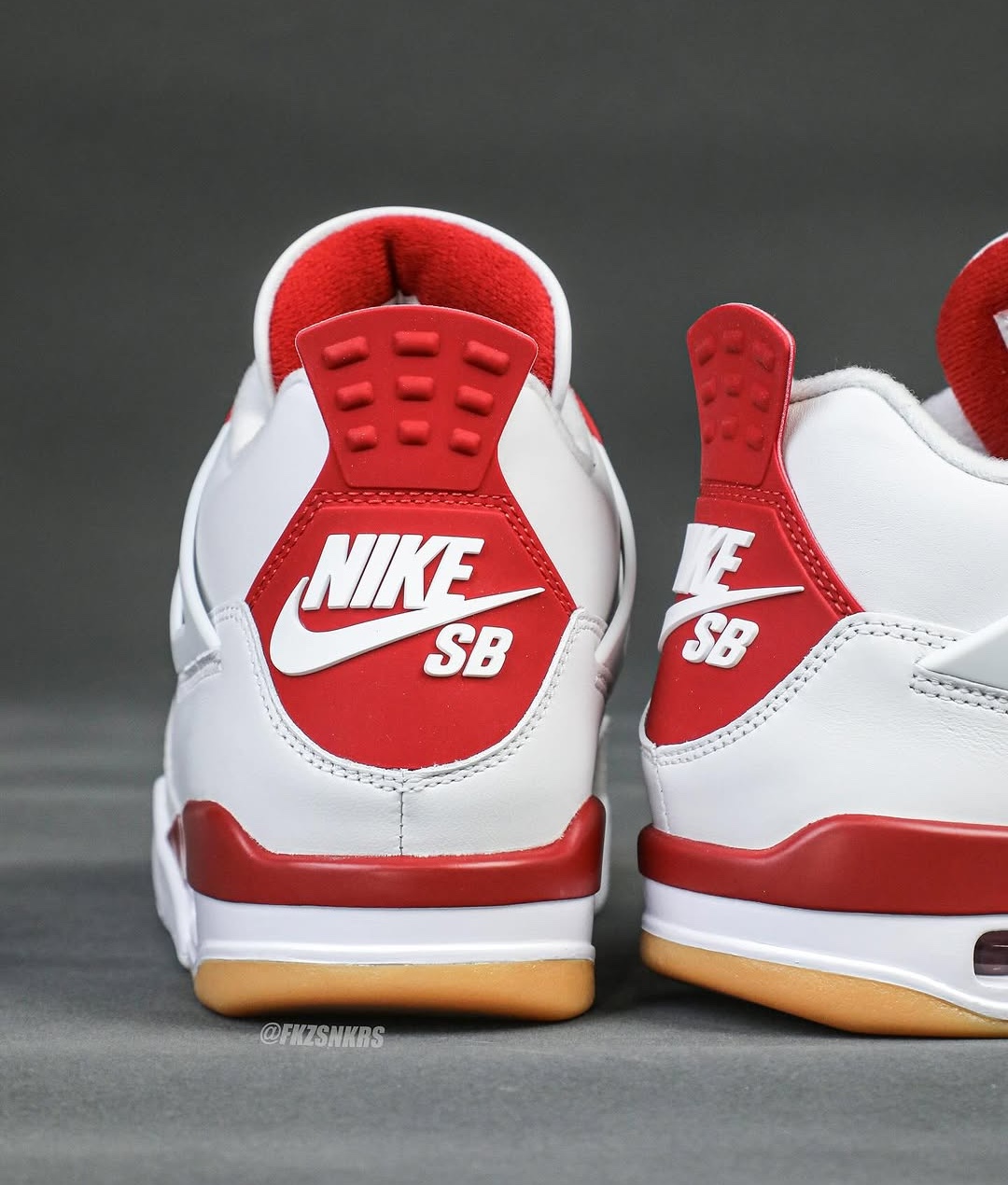 A rear view of the Nike SB x Air Jordan 4 'Varsity Red' Friends & Family, displaying the Nike SB logo on the heel, a signature detail of this skateboarding-influenced release.