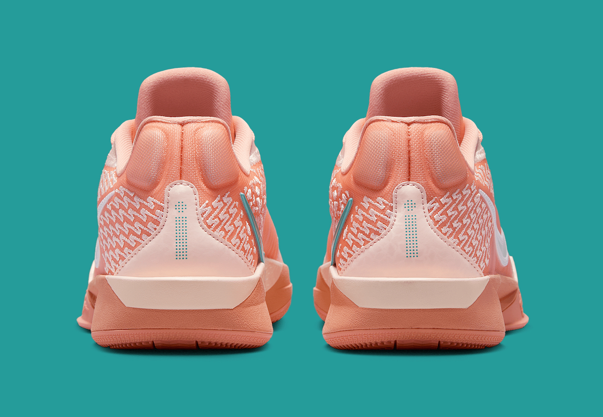 The heel of the Nike Sabrina 2 "Apricot Agate," featuring the pull tab, subtle teal branding details, and dual-tone heel counter for support.