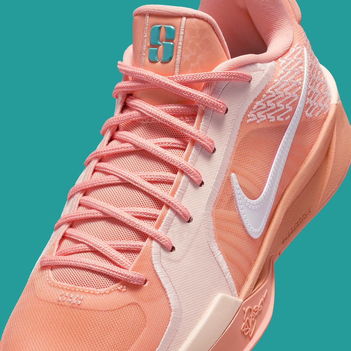 A close-up of the Nike Sabrina 2 "Apricot Agate" lateral side, focusing on the embroidered design, iridescent Swoosh, and herringbone outsole pattern.