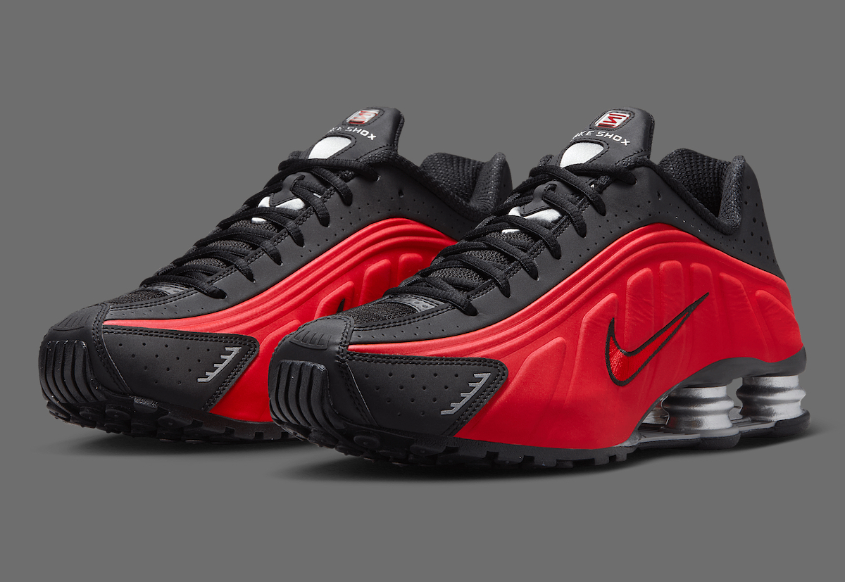 Nike Shox R4 Black/Red sneaker angled to show the red gradient upper, black overlays, and silver Shox cushioning.