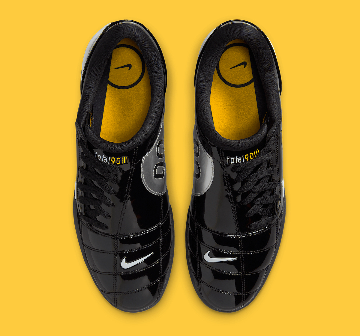 Top-down view of the Nike Total 90 III Black Patent, featuring black laces, yellow insoles with a Nike Swoosh logo, and Total 90 branding on the tongue.