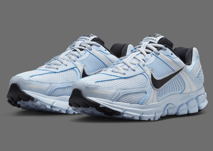 Angled shot of Nike Zoom Vomero 5 Blue Tint emphasizing the contrasting black outsole and side profile.