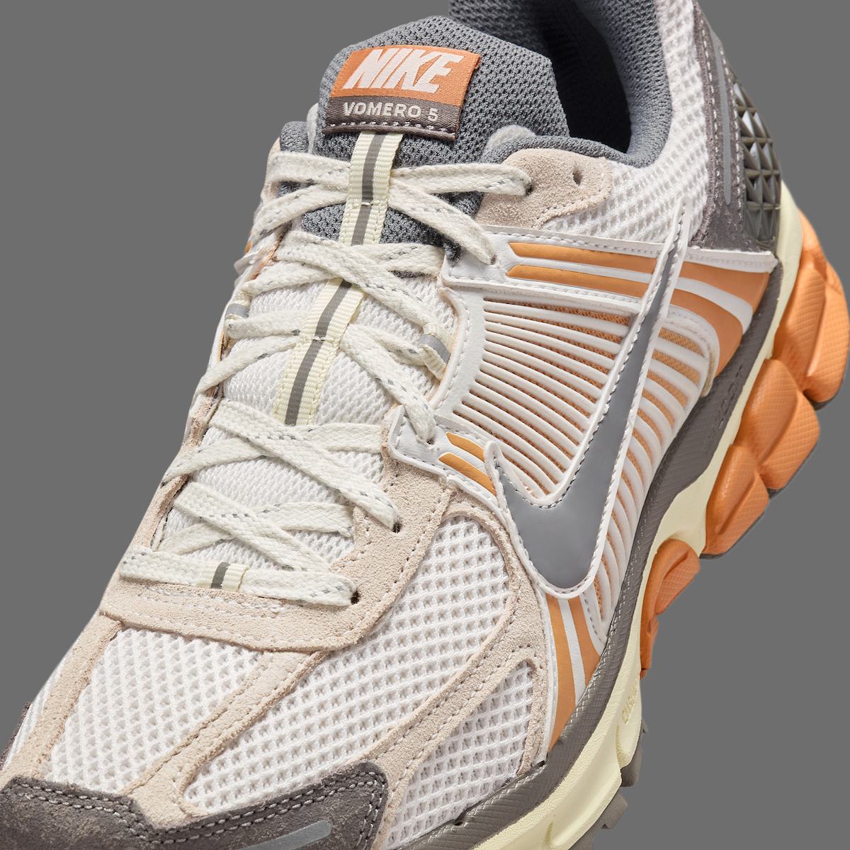 Close-up of the Nike Zoom Vomero 5 Copper Moon’s TPU quarter cage with copper detailing.