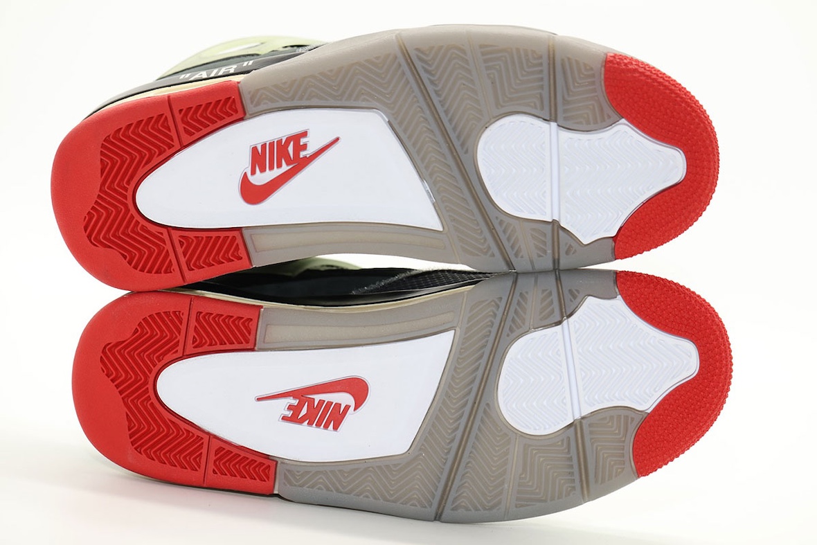 Sole view of Off-White x Air Jordan 4 Bred displaying red, white, and gray traction with Nike logo
