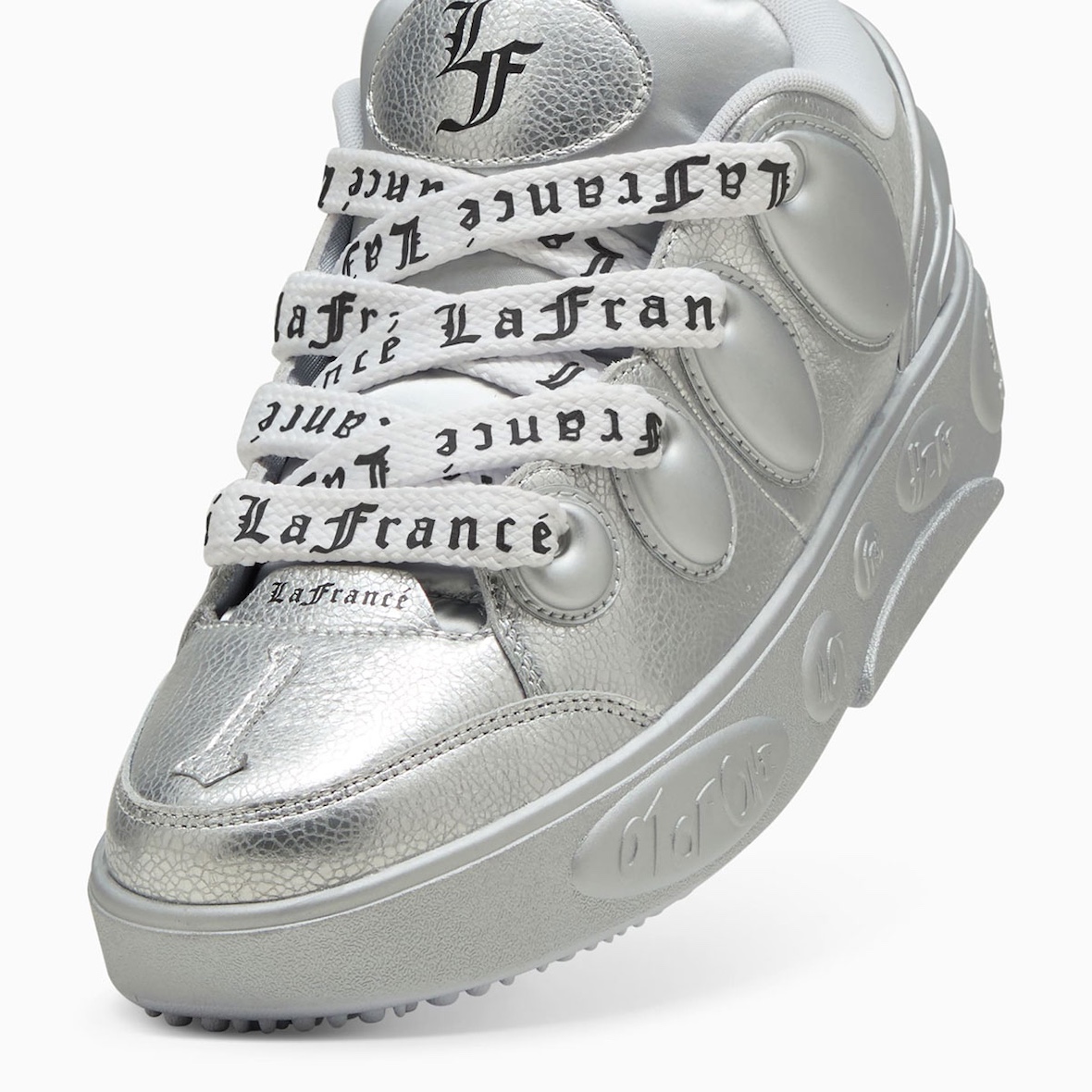 Detailed shot of PUMA LaFrance Silver sneaker laces with custom "LaFrance" text.