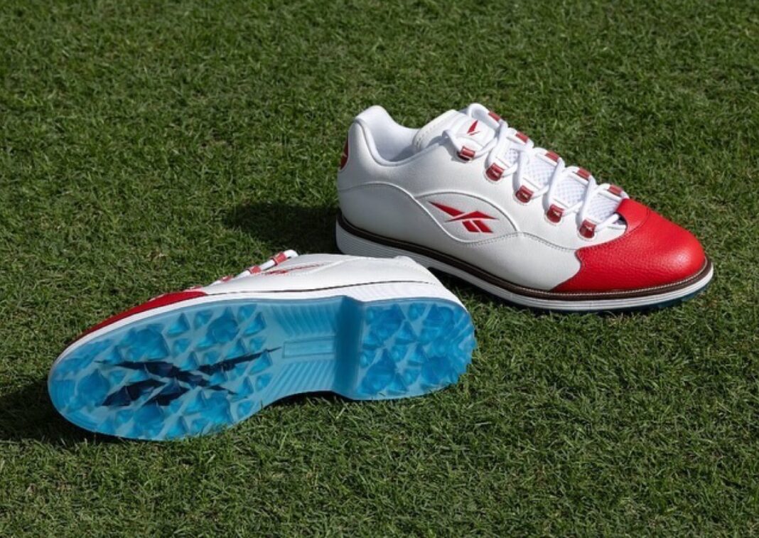 he Reebok Question Low Golf Shoe in white and red with an icy blue outsole on the golf course.