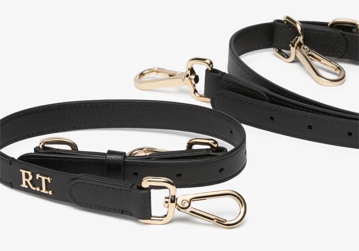 Close-up of removable leather strap with gold hardware and RT monogram on the Riccardo Tisci x Nike Mercer Bag