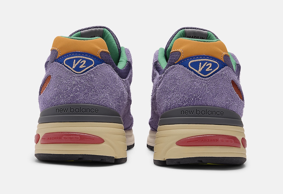 Rear view of the Salehe Bembury x New Balance 991v2 featuring a suede heel tab, 'V2' branding, and a dual-tone midsole with ABZORB cushioning for comfort.