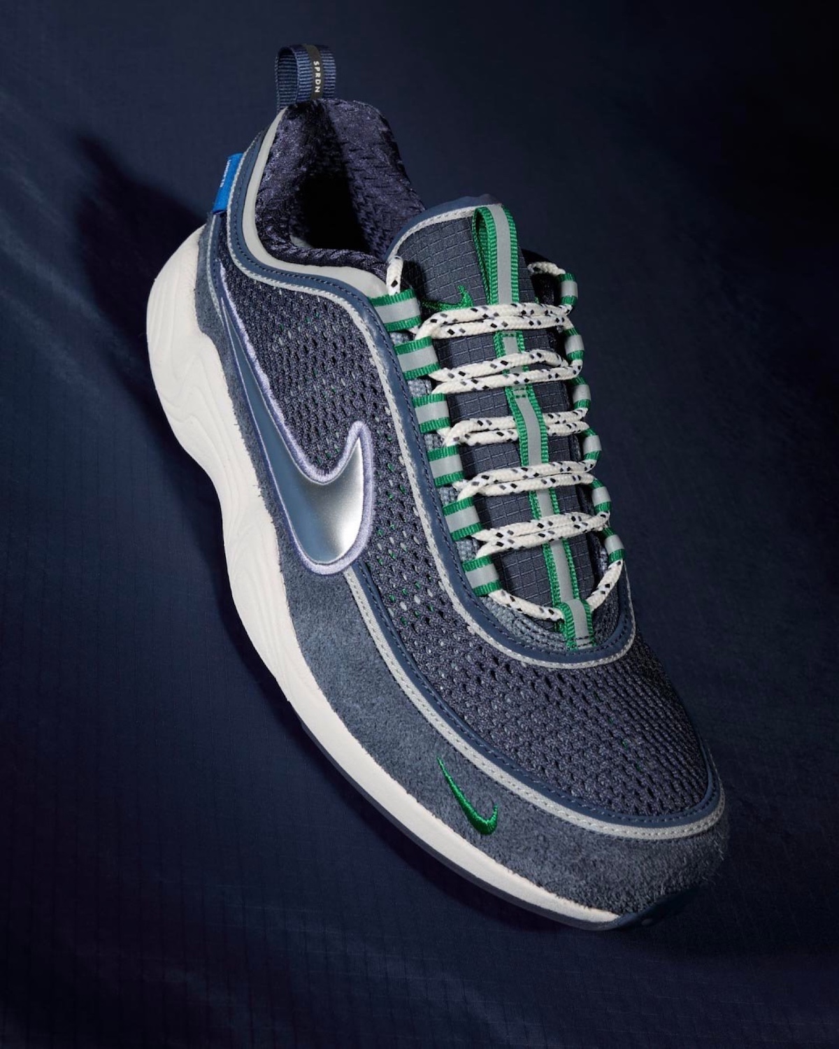 Undefeated x Nike Air Zoom Spiridon “Thunder Blue” featuring navy mesh and silver Swoosh