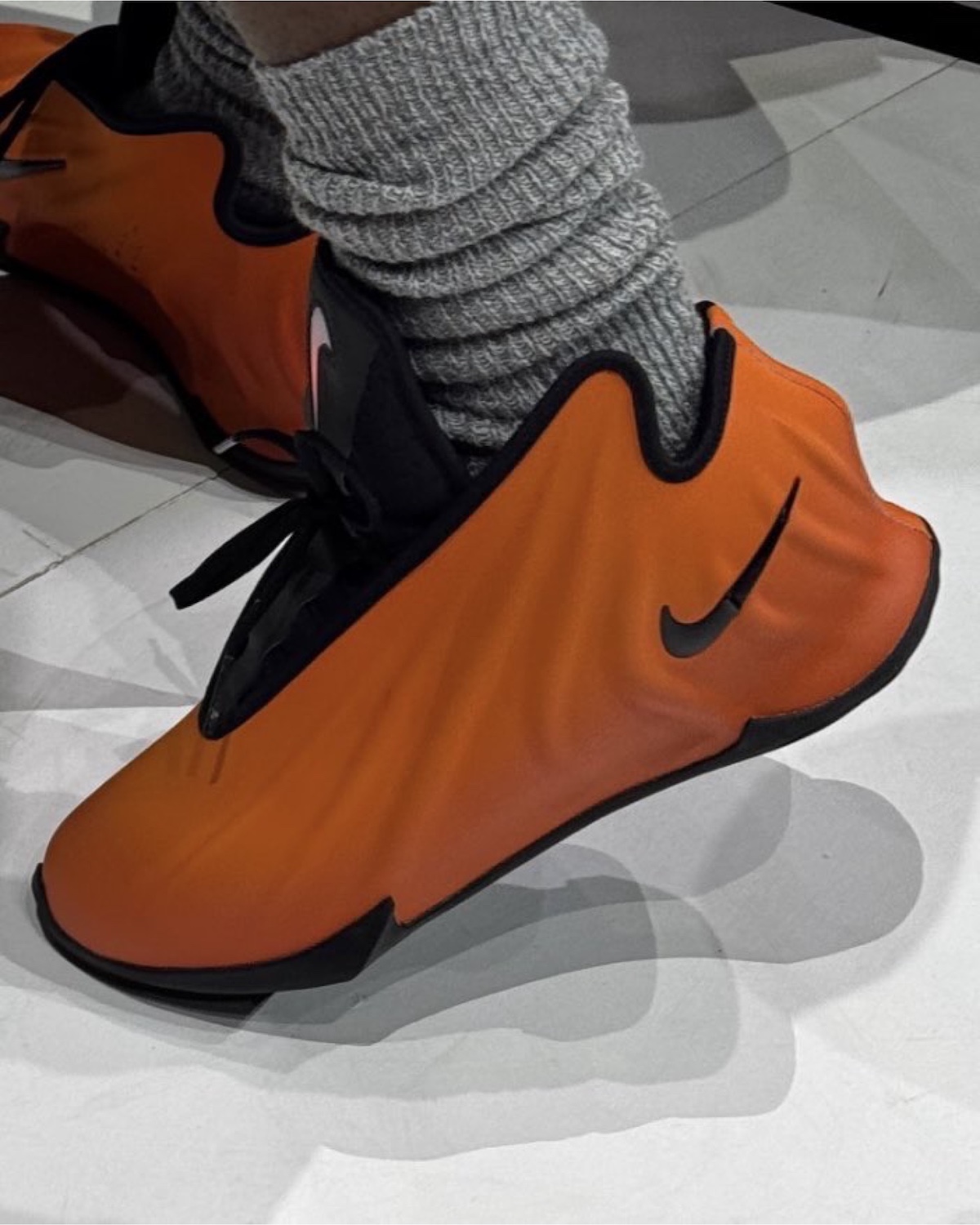 Close-up of the new Nike Basketball sneaker featuring an orange molded upper.