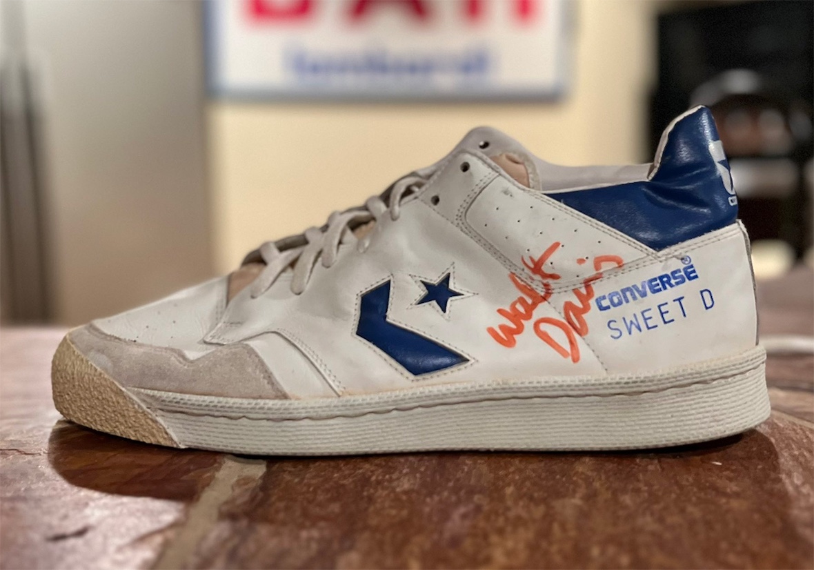Close-up of the Converse Startech Mid sneaker featuring blue accents, suede overlays, and "Sweet D" branding on the side panel, autographed by NBA legend Walter Davis in red ink.