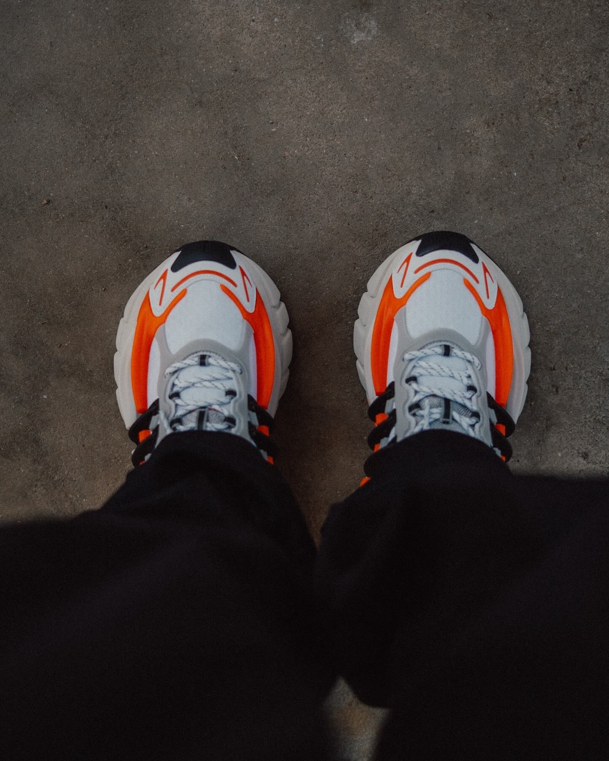 Pharrell x adidas Adistar Jellyfish On-Foot Look – A top-down perspective of the sneaker worn with black pants, highlighting the futuristic design and aggressive midsole sculpting.