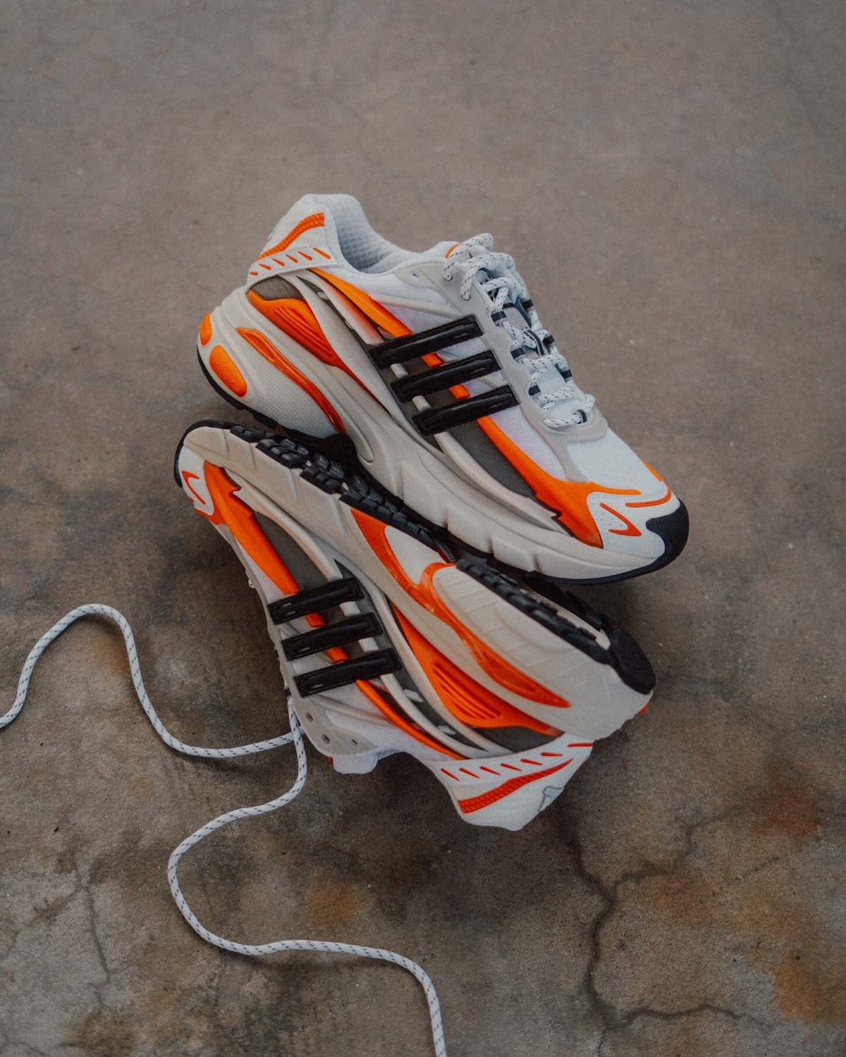 Pharrell x adidas Adistar Jellyfish Virginia Sneaker Close-Up – A detailed look at the Pharrell Williams x adidas Adistar Jellyfish in a white, black, and orange colorway, featuring bold overlays and futuristic design elements.
