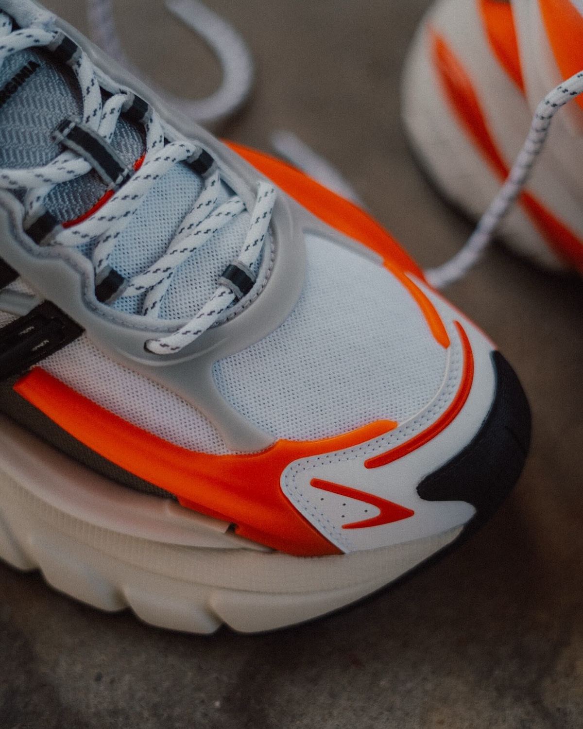 Pharrell x adidas Adistar Jellyfish Front View with Loose Laces – The sneaker displayed with loosely tied laces, emphasizing the bold three-stripe cage system and reflective accents.