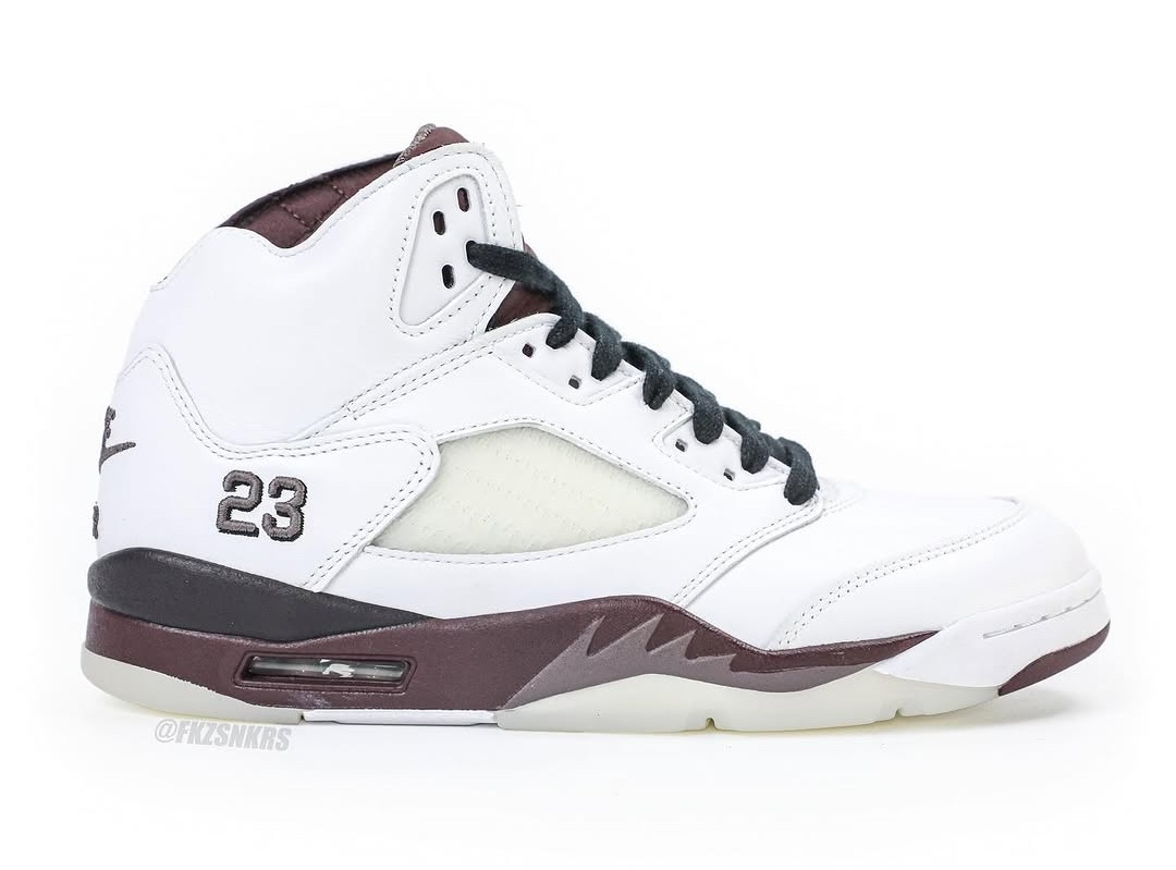  A side profile of the sneaker, highlighting the white leather upper, burgundy midsole, translucent mesh panels, and signature shark-tooth detailing.