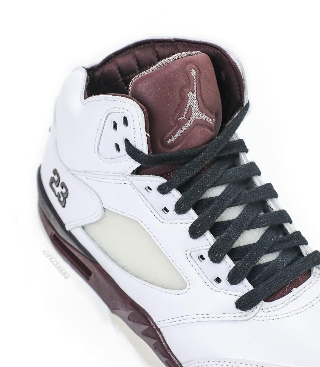 A detailed look at the sneaker’s burgundy quilted tongue with a stitched Jumpman logo, paired with black laces for a contrast against the white leather upper.