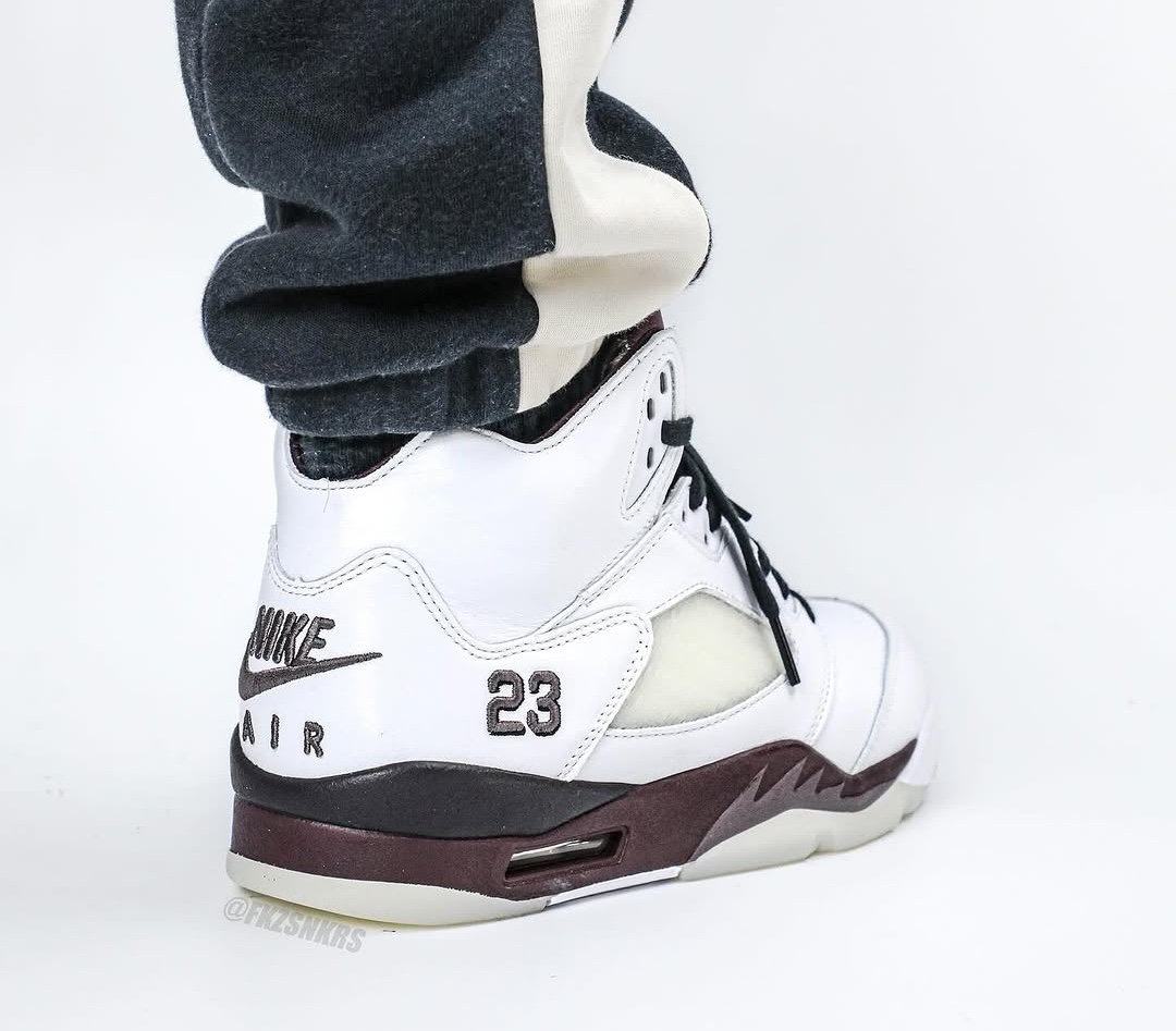 A rear view of the A Ma Maniére x Air Jordan 5 showcasing vintage 'Nike Air' branding in black, an embroidered '23' on the side, and a premium quilted inner lining in burgundy.