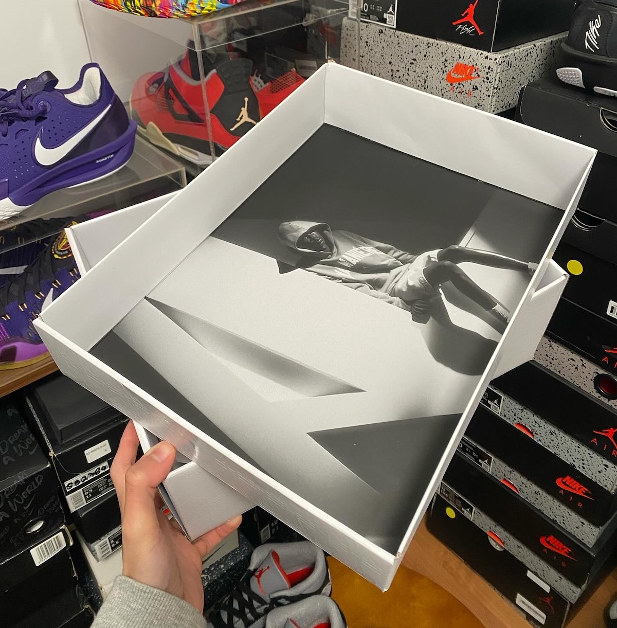Official shoebox design featuring A Ma Maniere’s signature black-and-white aesthetic.